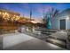Inviting backyard with stylish pergola, outdoor kitchen, concrete patio and a cozy seating area with fire pit at 822 Poplar St, Denver, CO 80220