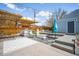 Outdoor space features a pergola with lights, outdoor kitchen and multiple seating areas at 822 Poplar St, Denver, CO 80220