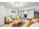 Finished basement with cozy seating, modern coffee table, and stylish staircase at 822 Poplar St, Denver, CO 80220