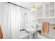 Cozy bathroom featuring a tub with shower, pedestal sink, and white subway tile at 822 Poplar St, Denver, CO 80220