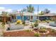 Charming single-story home featuring drought-tolerant landscaping, rock garden, and modern front door at 822 Poplar St, Denver, CO 80220