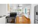 Open-concept layout with kitchen leading into bright living space, featuring hardwood floors at 822 Poplar St, Denver, CO 80220