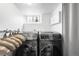 Modern laundry room with side-by-side washer and dryer and lots of storage at 822 Poplar St, Denver, CO 80220