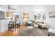 Bright, open-concept living space with hardwood floors and a view of the kitchen at 822 Poplar St, Denver, CO 80220