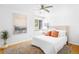 Bright main bedroom featuring a ceiling fan, hardwood floors, and warm neutral decor at 822 Poplar St, Denver, CO 80220