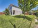 Lush backyard with green grass, mature trees, a cozy seating area, and privacy fencing at 1290 W Quincy Cir, Englewood, CO 80110