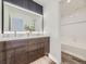Modern bathroom with a double vanity, a large mirror, and a separate shower and toilet room at 1290 W Quincy Cir, Englewood, CO 80110