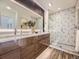 Elegant bathroom with double sink vanity, modern fixtures, and stylish patterned shower at 1290 W Quincy Cir, Englewood, CO 80110