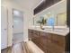 Well-lit bathroom with a double sink, granite countertop, and access to the toilet room at 1290 W Quincy Cir, Englewood, CO 80110