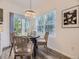 Cozy dining area featuring a modern chandelier, wood floors, and natural light from large windows at 1290 W Quincy Cir, Englewood, CO 80110