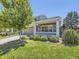 Charming home with a well-manicured lawn, cozy porch, and inviting curb appeal at 1290 W Quincy Cir, Englewood, CO 80110
