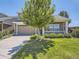 Charming home with a well-manicured lawn, cozy porch, and inviting curb appeal at 1290 W Quincy Cir, Englewood, CO 80110