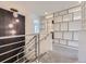 Bright hallway featuring unique decorative wall design and modern lighting fixtures at 1290 W Quincy Cir, Englewood, CO 80110