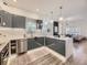 Modern kitchen featuring sleek cabinetry, quartz countertops, and stainless steel appliances at 1290 W Quincy Cir, Englewood, CO 80110