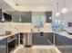 Stylish kitchen with stainless steel appliances, quartz countertops, and elegant lighting at 1290 W Quincy Cir, Englewood, CO 80110
