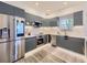 Contemporary kitchen with stainless steel appliances, gray cabinetry, and a smart refrigerator at 1290 W Quincy Cir, Englewood, CO 80110