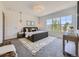 Spacious main bedroom with a large window, stylish rug, and modern furniture at 1290 W Quincy Cir, Englewood, CO 80110