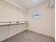 Functional walk-in closet with ample shelving, hanging space, and neutral decor at 1290 W Quincy Cir, Englewood, CO 80110