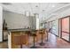 The bar has black countertops, three brown leather stools, hanging lights and glass doors to the pool area at 100 Park W Ave # 301, Denver, CO 80205