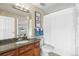 Cozy bathroom featuring a granite countertop, modern fixtures, a bathtub with shower, and decorative accents at 100 Park W Ave # 301, Denver, CO 80205