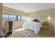 Bright bedroom featuring a queen-sized bed, large windows offering city views, and modern decor at 100 Park W Ave # 301, Denver, CO 80205