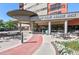Inviting building entrance with manicured landscaping and outdoor seating area at 100 Park W Ave # 301, Denver, CO 80205