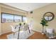 Bright dining area with large window, sleek table set, and plant at 100 Park W Ave # 301, Denver, CO 80205