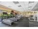 A brightly lit community gym with treadmills, elliptical machines, weight machines, and large windows at 100 Park W Ave # 301, Denver, CO 80205