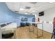 Laundry room with hardwood floors, light blue accent wall, flat screen TV, blue chairs and white folding table at 100 Park W Ave # 301, Denver, CO 80205