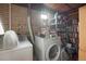 Functional basement laundry area with washer, dryer, and storage shelving at 3311 S Dahlia St, Denver, CO 80222