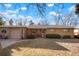 Inviting brick home with a cozy front porch and well-manicured landscaping at 3311 S Dahlia St, Denver, CO 80222