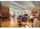 Bright living room featuring hardwood floors, exposed beam ceilings, and a brick fireplace at 3311 S Dahlia St, Denver, CO 80222