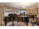 Sunlit music room featuring multiple grand pianos and large windows with awning at 3311 S Dahlia St, Denver, CO 80222