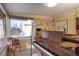 Bright music room featuring a grand piano, natural light, and ample space for seating at 3311 S Dahlia St, Denver, CO 80222