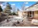 Back patio featuring a dining area with outdoor seating and well-manicured landscaping at 3311 S Dahlia St, Denver, CO 80222