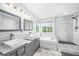 Elegant bathroom features a soaking tub, walk-in shower, and double vanity at 5774 S Genoa Ct, Aurora, CO 80015