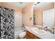 Bright bathroom with shower-tub combination, updated vanity and sink, and modern fixtures at 5774 S Genoa Ct, Aurora, CO 80015