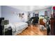 Bedroom with laminate floors, natural light, and neutral walls offers a comfortable and inviting space at 5774 S Genoa Ct, Aurora, CO 80015