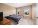 Cozy bedroom with neutral carpet and natural light provides a blank canvas for personalization at 5774 S Genoa Ct, Aurora, CO 80015