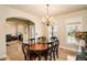 Elegant dining room featuring a chandelier, hardwood floors, and large windows at 5774 S Genoa Ct, Aurora, CO 80015