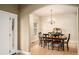 Bright dining room boasts hardwood floors, chandelier and large window for an elegant and inviting space at 5774 S Genoa Ct, Aurora, CO 80015