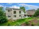 Lovely exterior view featuring a well-manicured backyard, pond, patio, and ample sunlight at 5774 S Genoa Ct, Aurora, CO 80015