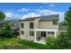 Back exterior with covered patio, well-maintained lawn, and large windows to let in natural light at 5774 S Genoa Ct, Aurora, CO 80015