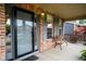 Charming front porch with brick columns, bench, and welcoming entrance at 5774 S Genoa Ct, Aurora, CO 80015