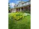 Beautifully landscaped front yard with colorful flowers and lush green grass complementing the home's exterior at 5774 S Genoa Ct, Aurora, CO 80015