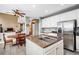 Bright kitchen with an island cooktop, white cabinets, and granite countertops at 5774 S Genoa Ct, Aurora, CO 80015