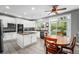Modern kitchen with white cabinets, granite countertops, and stainless steel appliances at 5774 S Genoa Ct, Aurora, CO 80015