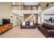 Spacious living room with a balcony, staircase, and views of the kitchen at 5774 S Genoa Ct, Aurora, CO 80015