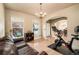 Inviting living room features hardwood floors, multiple windows and seamless flow to the dining room at 5774 S Genoa Ct, Aurora, CO 80015