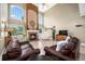 Bright living room with a fireplace, large windows, and hardwood floors at 5774 S Genoa Ct, Aurora, CO 80015